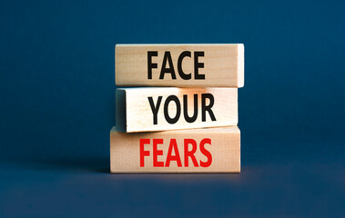 Face your fears and support symbol. Concept words Face your fears on wooden blocks. Beautiful grey...