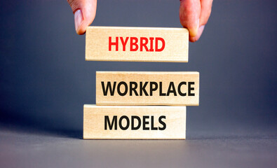 Hybrid workplace models symbol. Concept words Hybrid workplace models on wooden blocks. Businessman...