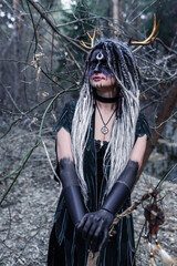 Naklejka premium Forest witch in a pine forest