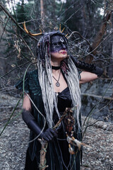 Naklejka premium Forest witch in a pine forest
