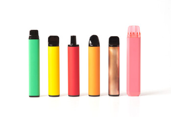 A set of colorful disposable electronic cigarettes of different shapes on a white background. modern smoking.