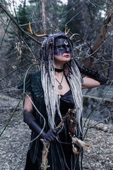 Naklejka premium Forest witch in a pine forest