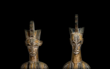 Couple, partners, african sculpture on black background. Background concept.