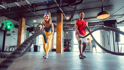 Functional training with battle rope in crossfit gym for better fitness