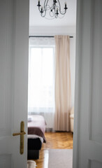 Fototapeta na wymiar vintage white door opening into bedroom