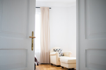 Fototapeta na wymiar vintage white door opening into bedroom