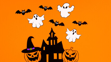 Orange background with creative arrangement of creepy Halloween stickers. Copy space flat lay