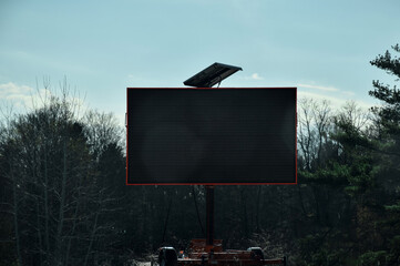 Large blank digital electronic sign at side of road on highway