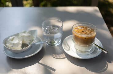 glass of iced coffee on the table at summer terrace