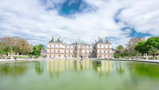 The Luxembourg Palace in The Jardin du Luxembourg or Luxembourg Gardens in Paris, France. View on the main facade and water fountain pond timelapse hyperlapse