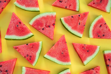 Watermelon pattern. Sliced watermelon on yellow background, top view