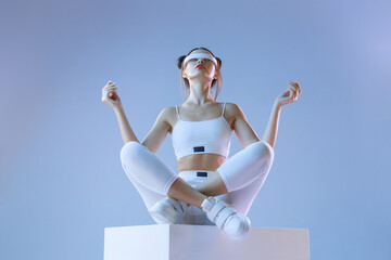 Woman in futuristic costume. Girl in glasses of virtual reality while touching air. Augmented...