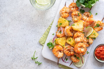 kebab skewers of barbecued shrimp with a pineapple