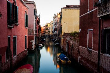 The old bridge made with wooden on the typical canal in Venice