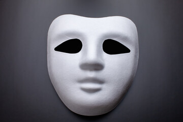 white carnival mask on black background