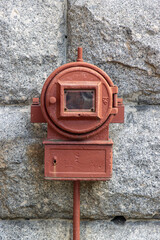 Old fire alarm on outdoor wall