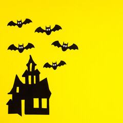 Creepy Horor house with bats on yellow background. Halloween holidays copy space background. Flat lay