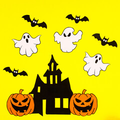 Yellow background with creative arrangement of creepy Halloween stickers. Flat lay