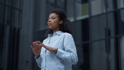 Focused worker meditating at office building closeup. Calm businesswoman relax