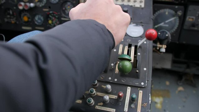 Pilot push thrust lever handle for takeoff a old plane in the cockpit and push back the lever.