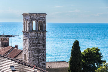 view to an old tower at the sea in porec, croatia