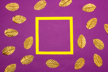 yellow frame with golden leaves around the frame on a purple background, creative art design
