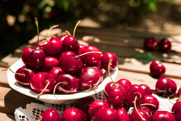 a white bowl filled with ripe cherries on the table