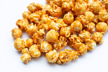 Honey caramel popcorn on white background.