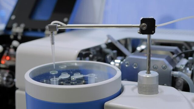 Close up view: atomic absorption spectrometer for analyzing concentration of elements in liquid sample at pharma exhibition. Chemistry, pharmaceutical and laboratory equipment concept