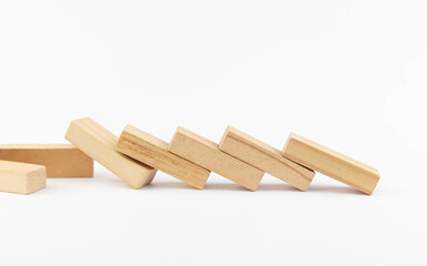 Wooden toy blocks on a white background concept of fall and failure. Decline. Crisis