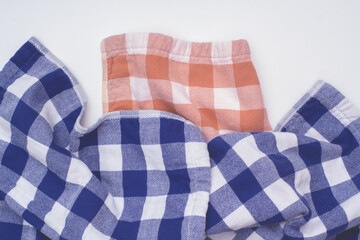 Fototapeta na wymiar Checkered kitchen towels. Flat lay view.