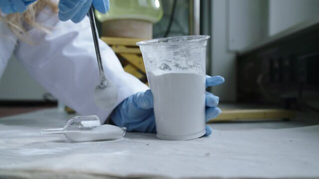 White powder put into scoop for science laboratory experiment.