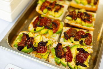 Appetizing sandwiches with avocado, fig jam and stewed peppers