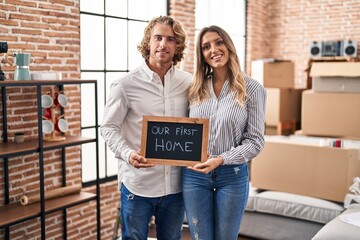 Young couple moving to a new home smiling with a happy and cool smile on face. showing teeth.