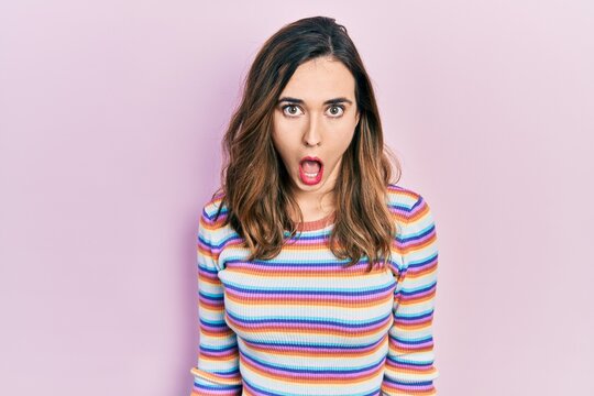 Young hispanic girl wearing casual clothes afraid and shocked with surprise and amazed expression, fear and excited face.