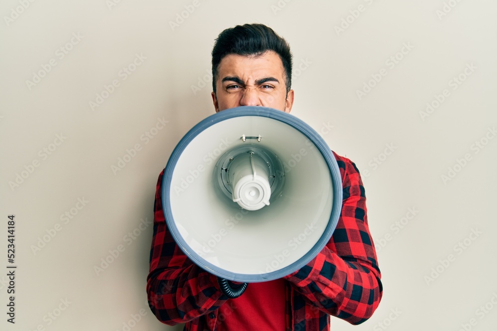 Wall mural hispanic man with beard screaming with megaphone