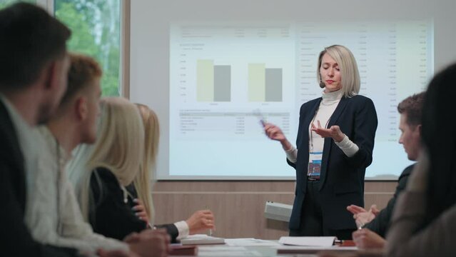 woman is speaking in conference or business meeting, female financial expert is educating specialists