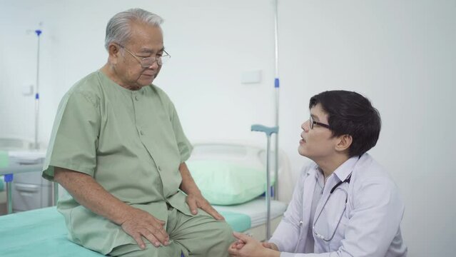 Happy old elderly Asian patient or pensioner and a doctor smiling, doing exercise, working out  in nursing home in hospital. Senior people lifestyle activity recreation. Health care physical therapy.