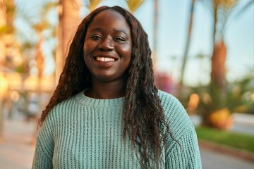 Young african woman smiling happy at the city