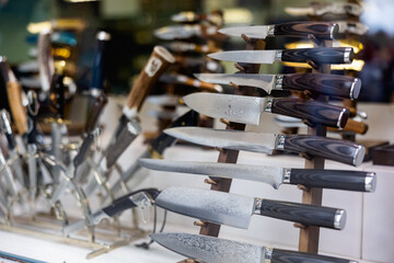 Damascus steel knives in showcase. Toledo knives collection in souvenir shop.
