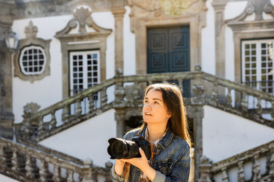 Interested woman photographer taking pictures of scenic view of Mateus palace, Vila Real, Portugal