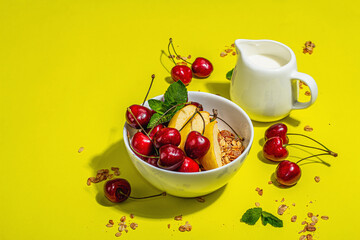 Summer breakfast concept. Healthy morning food. Ripe cherries, apples, milk and granola