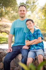 Fototapeta premium Outdoor portrait of mixed race Chinese and Caucasian father and son.