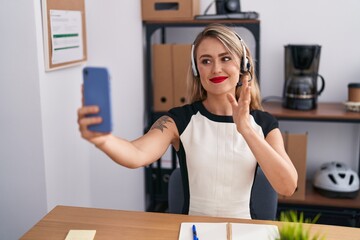 Young beautiful hispanic woman call center agent having video call at office