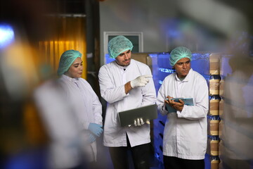 Factory worker inspecting production line of drink production in factory , Concept of food industry