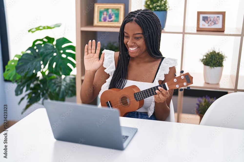 Sticker african american woman having online ukulele class at home