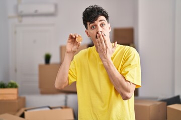 Hispanic man holding bitcoin at new home looking at the camera blowing a kiss being lovely and sexy. love expression.