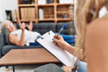 Senior grey-haired woman patient having psychologist session at psychology center