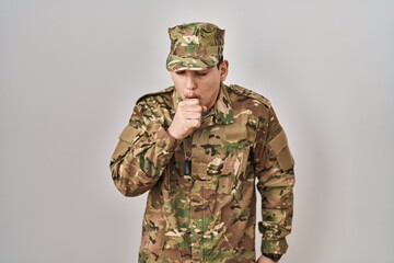 Young arab man wearing camouflage army uniform feeling unwell and coughing as symptom for cold or bronchitis. health care concept.