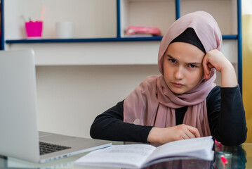 A sad and stressed Muslim student girl while learning for school. 